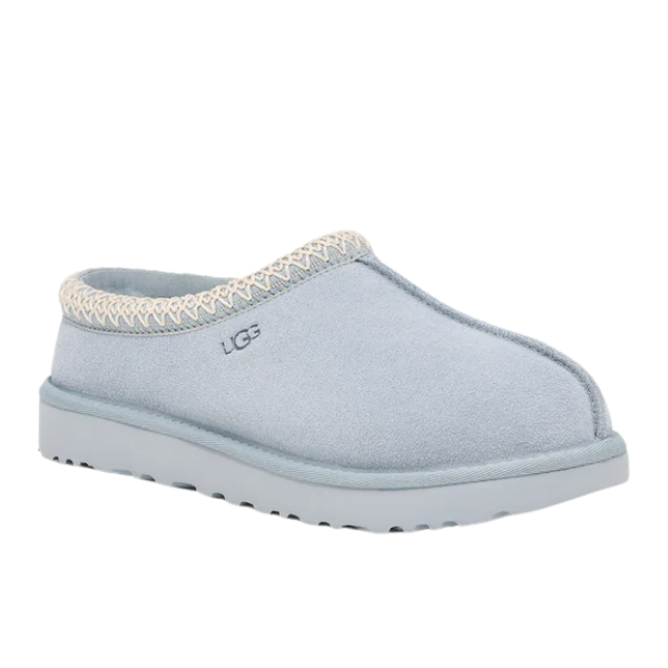 The UGG Womens Tasman Slipper in Sea Foam features a thick sole, soft suede upper, cream woven trim, plush wool lining, and embroidered UGG logo.