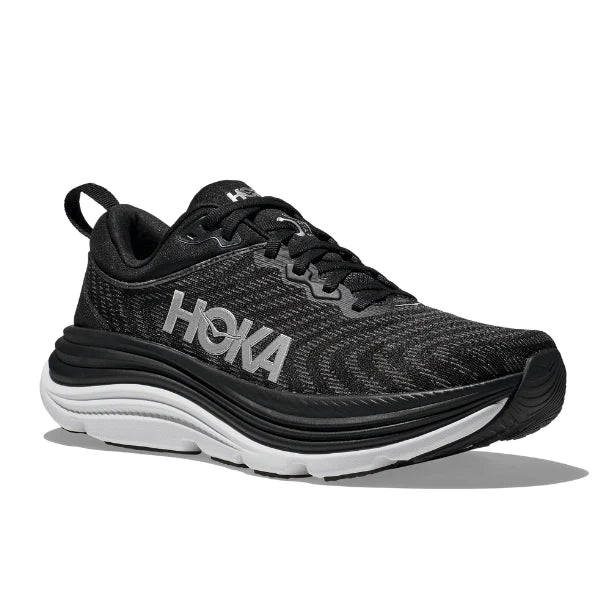The HOKA Mens Gaviota 5 (Medium Width) in Black/White features a cushioned sole with Stabilizing H-Frame technology, black laces, and the white HOKA logo on the side, shown against a white background.