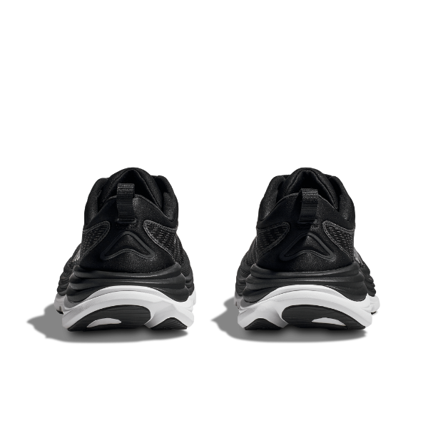 A pair of HOKA Mens Gaviota 5 Wide Black/White sneakers with a Creel jacquard mesh upper and white soles is shown from the back against a plain white background.