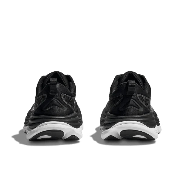 A pair of HOKA Mens Gaviota 5 (Medium Width) black/white sneakers viewed from the back, showcasing white soles, textured details, and H-Frame support—ideal for plantar fasciitis. Shown against a white background.