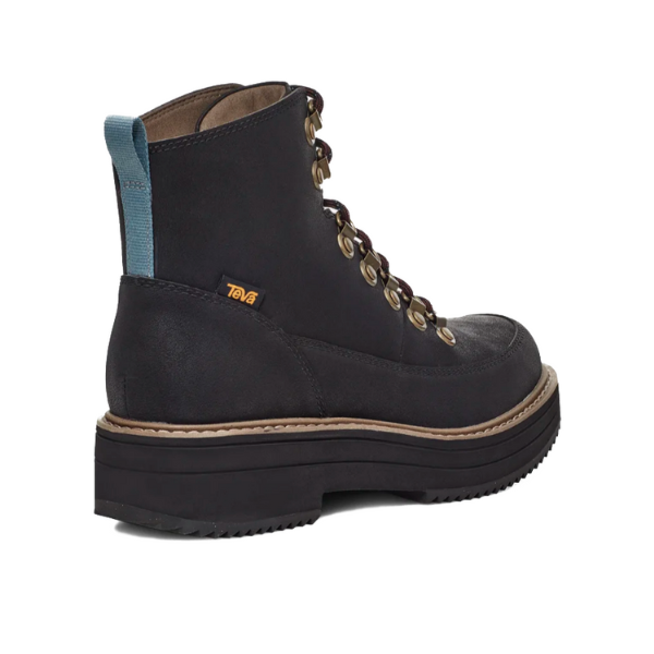 The Teva Womens Midform Boot Black features metal eyelets, a thick treaded sole, brown welt, blue heel pull tab, small yellow Teva logo tag, and MAX-COMF insole technology for superior comfort.