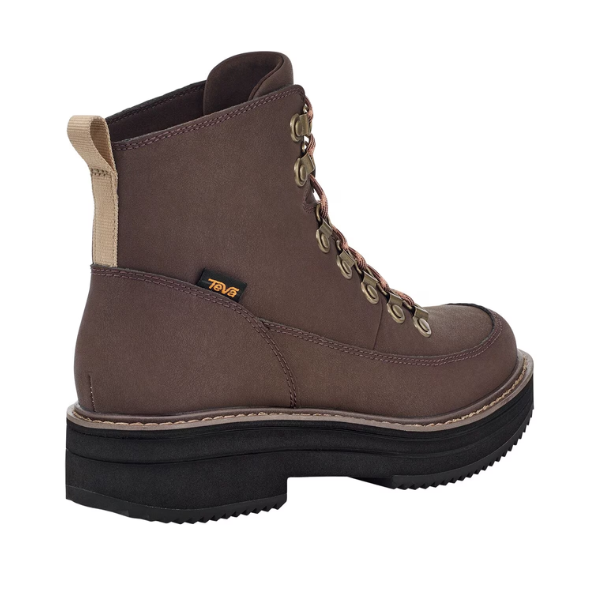 The Teva Womens Midform Boot Bracken features brown lace-up styling with metal eyelets, a tan heel pull tab, black chunky sole, visible stitching, and a small black tag with yellow logo near the ankle.