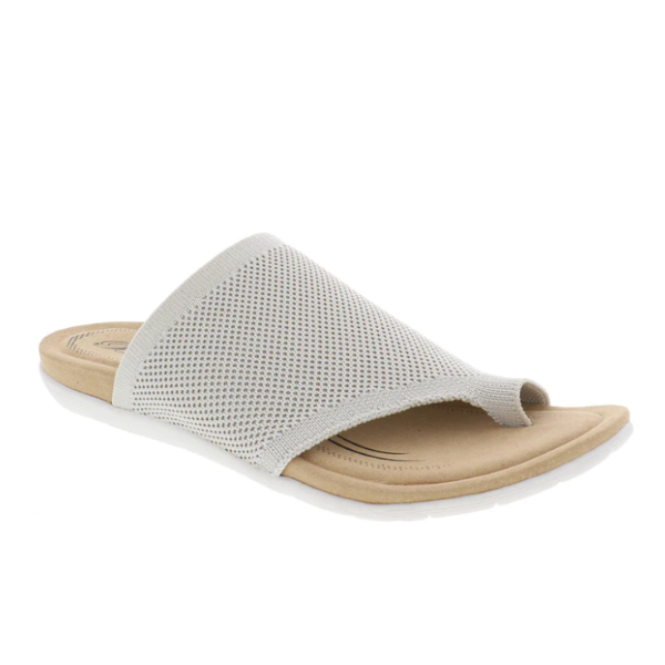 The BIZA FOOTWEAR Biza Womens Lavish Sand is a beige slip-on travel sandal with a textured breathable upper, open toe, cushioned tan footbed, and white flexible sole, displayed on a white background.