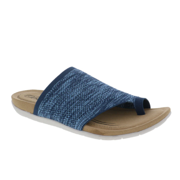 The BIZA FOOTWEAR Womens Lavish Denim is a blue stretch knit slip-on sandal featuring a toe loop, tan cushioned footbed, and white sole—perfect for travel with its comfort and style.