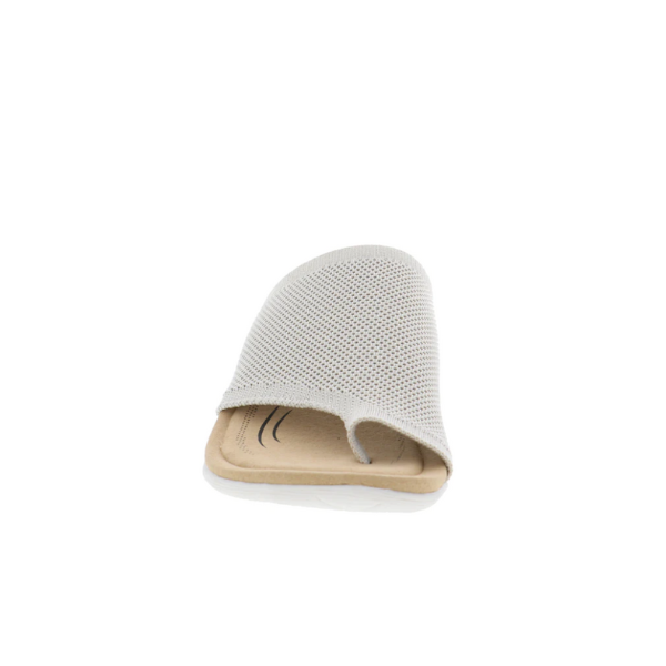 The BIZA FOOTWEAR Biza Womens Lavish Sand is a beige open-toe slide sandal with a sporty stretch knit upper and flat sole, designed for comfort, shown from the front on a white background.