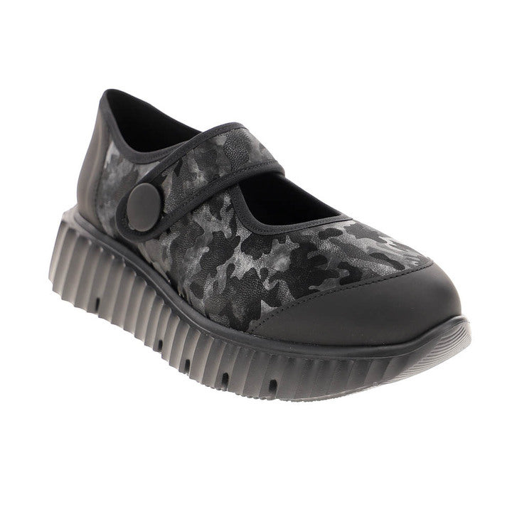 The Sovella Womens Jessica Black Camo by SOVELLA is a lightweight Mary Jane with black and gray camo pattern, thick ridged sole, and strap with a round button—sporty footwear ideal for everyday style.
