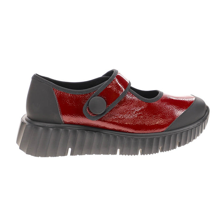 The Sovella Womens Jessica Red by SOVELLA is a patent leather Mary Jane shoe with a thick black ridged sole, large button strap, and offers lightweight, breathable comfort with modern style.