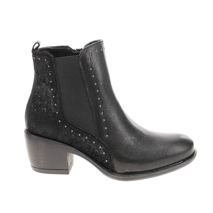 The SOVELLA Womens Misty Black boot is a stylish black ankle boot with a low block heel, side elastic panels, metallic stud accents, and textured back and sides—designed for comfort and to help relieve heel pain.