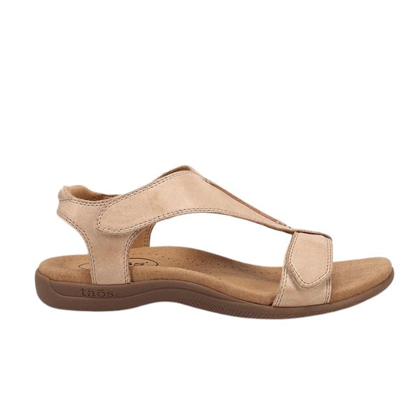 The Taos Womens The Show Stone by TAOS is a beige leather sandal with a low brown sole, arch support, supportive back strap, and Wide cutout front strap. This open-toe style delivers comfort—perfect for casual wear.