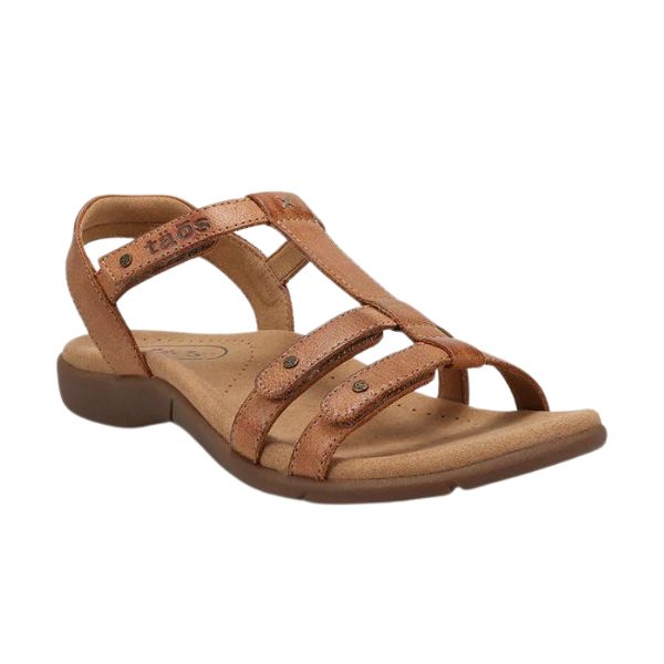 The TAOS Womens Trophy 2 Honey is a brown strappy leather sandal with an open toe, low heel, adjustable straps, and cushioned Taos Soft Support™ footbed for comfort, plus added arch and metatarsal support.