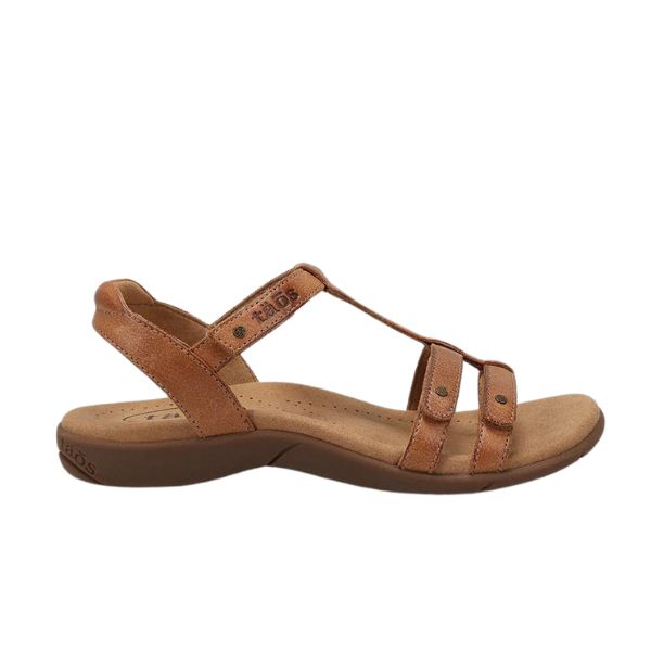 The TAOS Womens Trophy 2 Honey sandal features brown leather straps, an open toe, adjustable ankle strap, cushioned sole, and Taos Soft Support™ footbed for superior arch and metatarsal support—ideal for all-day comfort.