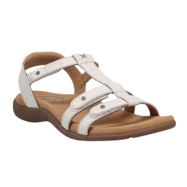 The TAOS Womens Trophy 2 Icee is a beige leather sandal with open toe and heel, cushioned brown sole, adjustable riveted straps, offering arch and metatarsal support for comfortable casual wear.
