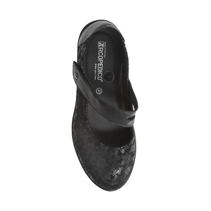 Top view of the ARCOPEDICO Womens Cosmo Black Mary Jane shoe, featuring a floral pattern, single instep strap, and branded insole—designed to relieve foot pain.