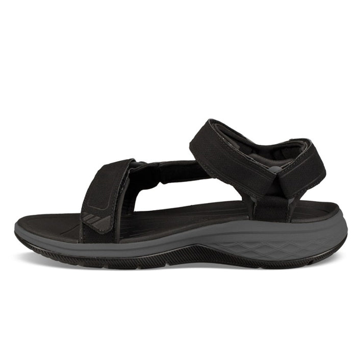 The Teva Mens Strata Universal Black is an open-toe hiking sandal with adjustable Velcro straps and a thick, textured gray sole for comfort, support, and foot pain relief.