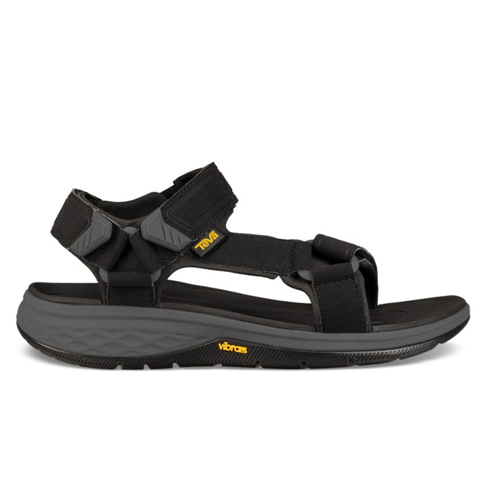 The Teva Mens Strata Universal Black by Teva is a hiking sandal with adjustable straps, a cushioned sole for comfort and pain relief, and features the Vibram logo—ideal for outdoor or casual use.