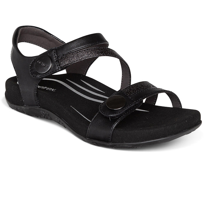 The Aetrex Womens Jess Black by Aetrex is a black open-toe sandal with two adjustable straps, a back strap, decorative stitching, and a memory foam footbed for comfort and casual wear.