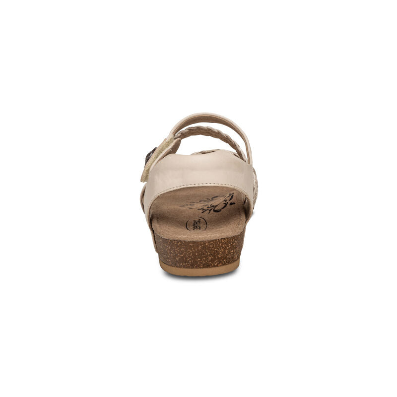 Rear view of the Aetrex Womens Jillian Ivory sandal by Aetrex, featuring a cork wedge heel, ankle strap, floral insole pattern, and plush memory foam cushioning for comfort against a white background.