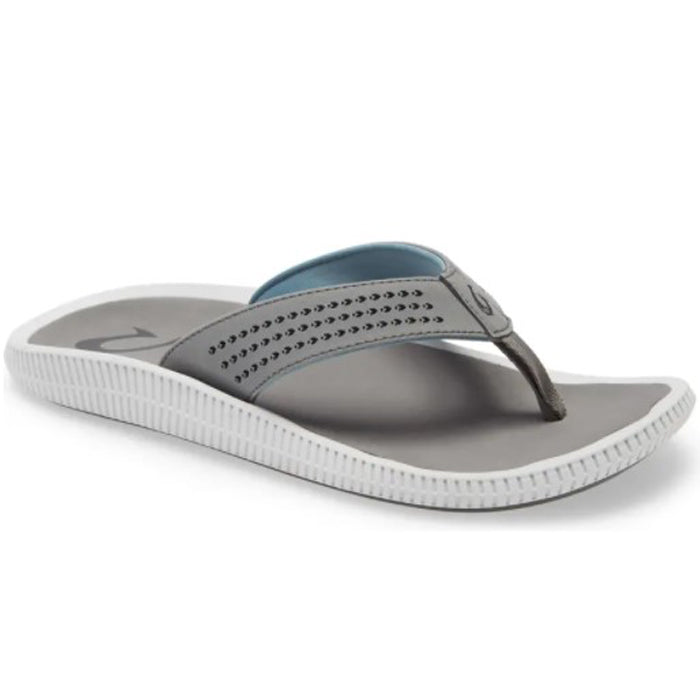 The OluKai Mens Ulele in Stone/Stone features a gray perforated strap with logo, light blue inner lining, and textured white sole, blending style and comfort in this water-friendly sandal displayed on a white background.