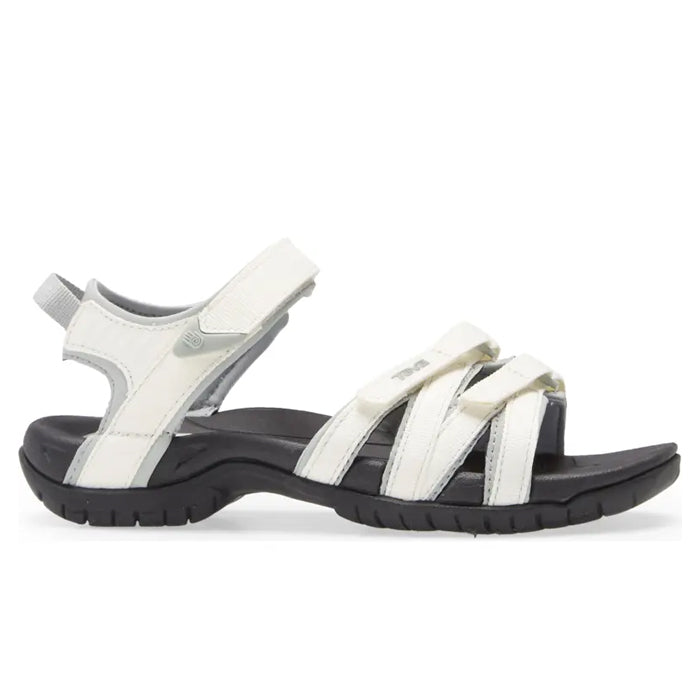 The Teva Womens Tirra White/Black sandal by Teva features adjustable Velcro straps, arch support, and a black sole—perfect as a versatile choice for active or casual wear.