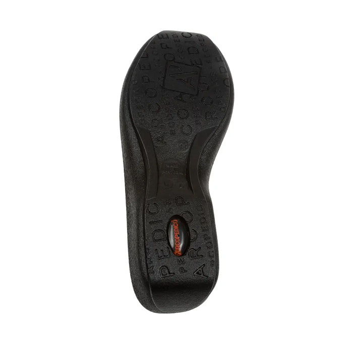 The image displays the black rubber sole of the ARCOPEDICO Arcopedico Womens L19 Stretch Bootie, viewed from below, featuring textured patterns, embossed branding, and an orange label that highlights its orthopedic outsole for foot pain relief.