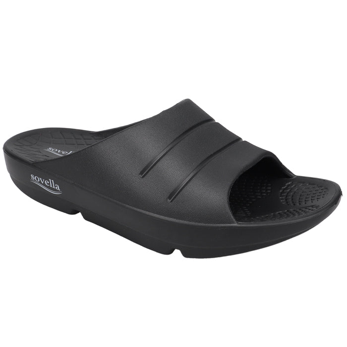 The Sovella Men’s PF Slide Black is a slip-on sandal with two raised stripes, a textured footbed, open toe, slight heel lift, and arch support for comfort recovery. Sovella branding is on the side of the sole near the heel.
