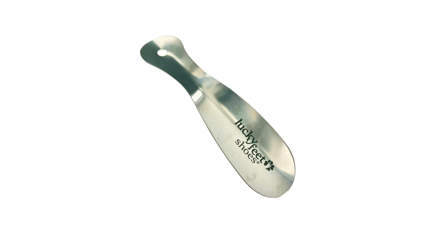 The Lucky Feet Shoes Metal Shoe Horn by Lucky Feet Shoes is shown against a white background, featuring the brand logo.