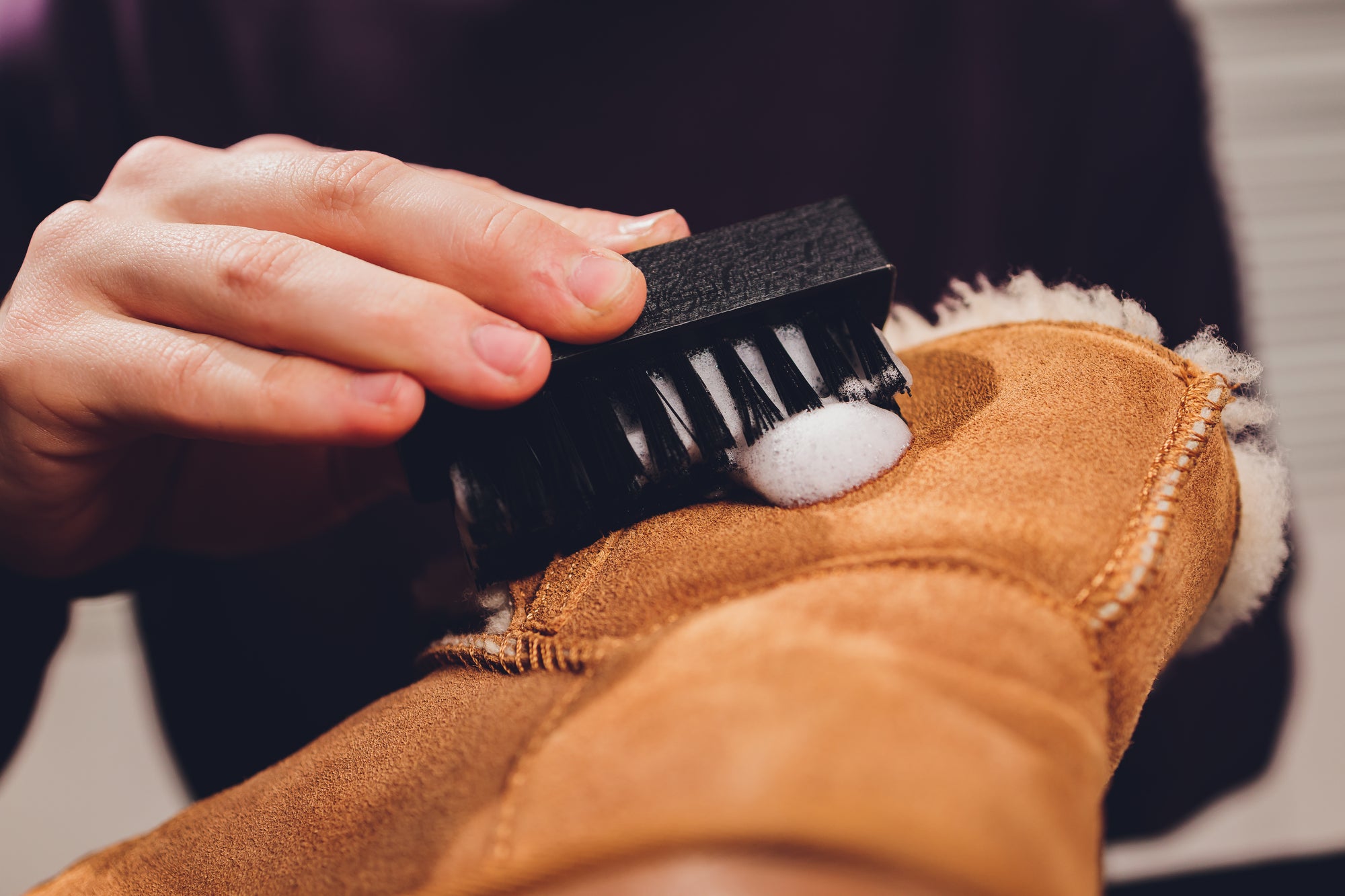 man cleaning suede boots