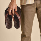 OLUKAI Men's Hiapo Rum/Dark Wood sandal, leather-wrapped anatomical footbed with arch support, detail view.