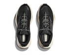 Top view of HOKA Mens Transport Wide Black/White sneakers with white soles, unique patterned laces, and a VIBRAM outsole for superior traction, displayed side by side on a plain background.