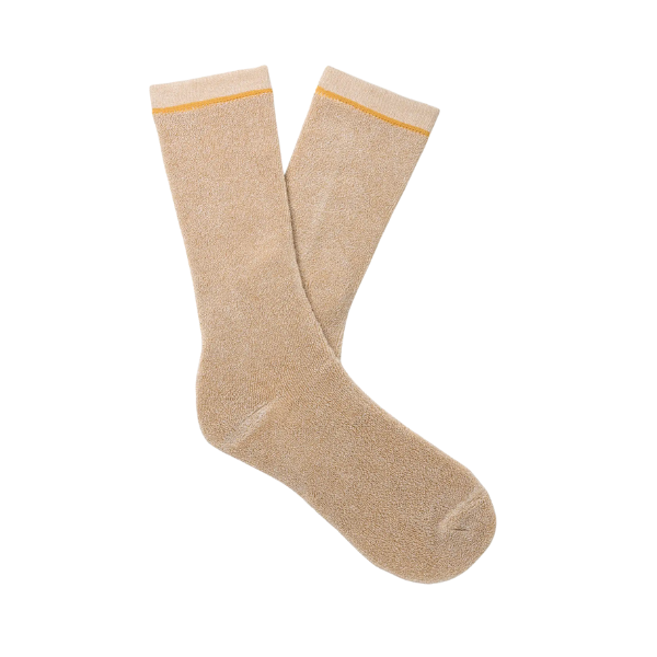 A pair of UGG Men's Kyro Crew Socks in Mustard Seed, featuring a thin yellow stripe near the top, laid flat on a white background.