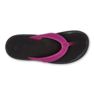 A top-down view of the OLUKAI W-Ohana Orchid flip-flop sandal in black with a Wide magenta strap and visible stitching, designed for anatomical comfort.