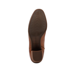 Bottom view of the Aetrex Women's Reagan Heel Boot in Cognac shows a textured rubber sole with fine horizontal grooves for grip. The AETREX WORLDWide INC logo appears near the heel. Leather ankle boot offers arch support. White background.