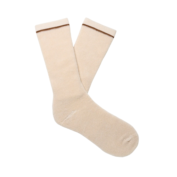A pair of UGG Men's Kyro Crew Socks in cream, featuring a thin brown stripe near the top, laid flat on a white background.