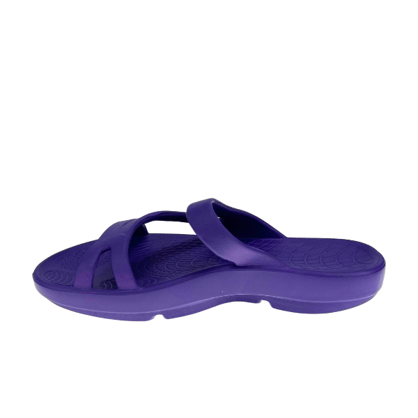 The SOVELLA Sovella Womens PF Slide Purple is a recovery sandal with arch support, thick sole, and two crossing straps, shown from the side on a white background.