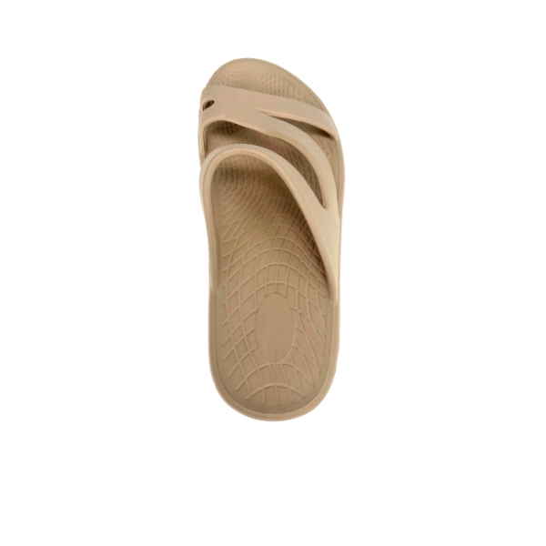 The Sovella Womens PF Slide Beige by SOVELLA is a single beige slip-on recovery sandal with a textured sole and open sides, offering superior arch support, displayed against a white background.