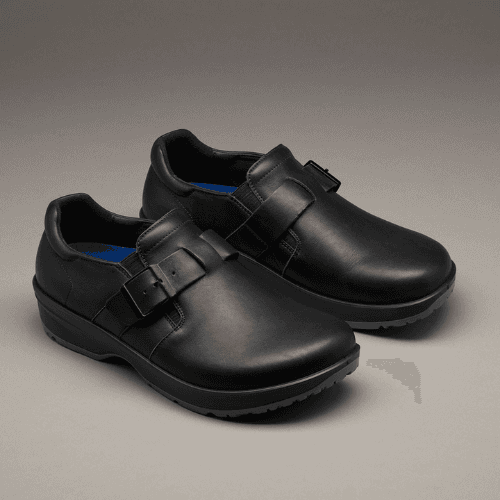 A pair of black leather Birkenstock London closed-toe shoes on a grey background.