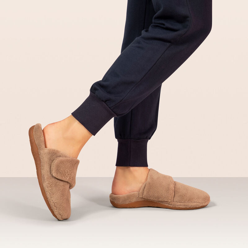 AETREX Women's Mandy Coffee slippers worn at home, plush closed-toe house shoe with foot pain relief support.