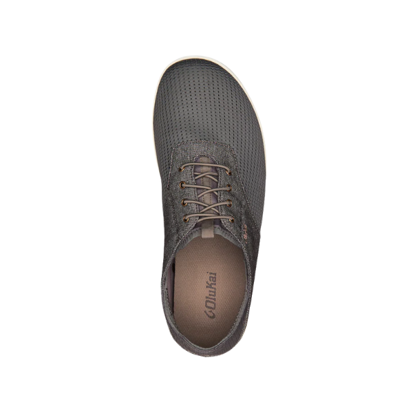 Top view of an OLUKAI Men's Nohea Moku Sneaker in grey with perforated material, brown laces, and “OluKai” logo on the insole, displayed against a white background.