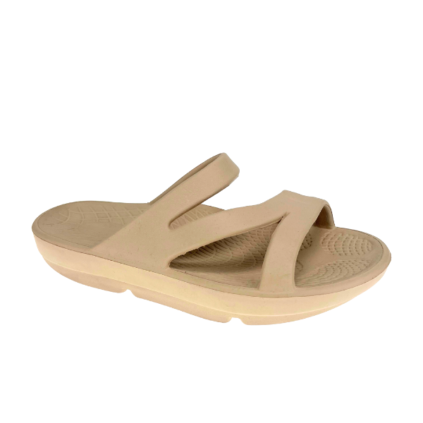 The SOVELLA Sovella Womens PF Slide Beige sandal features two thick crisscross straps, a textured footbed with rebound technology, a slightly elevated contoured sole, and enhanced arch support for all-day comfort.