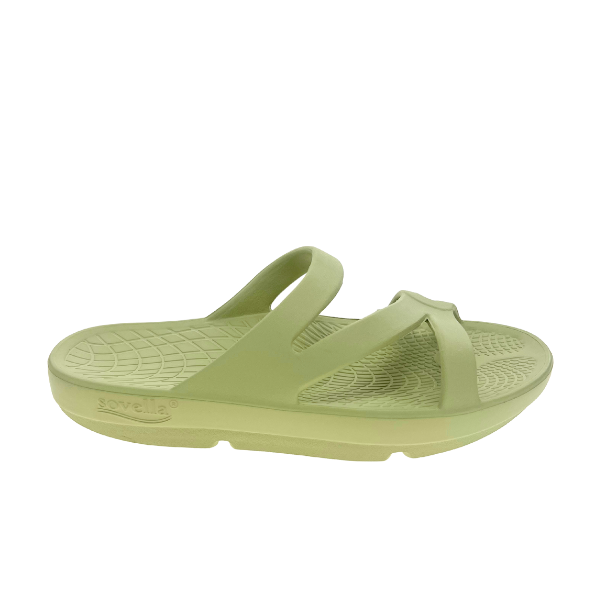 The Sovella Womens PF Green Slide by SOVELLA features a light green design with two Wide straps, a contoured textured footbed, rebound technology for arch support, a thick sole, and an open toe.