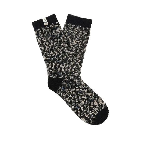The UGG Women's Cozy Chenille Socks in black, grey, and white feature a soft, textured design with a small white tag near the top. These lounge socks from UGG are pictured overlapping on a white background.