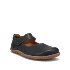 The TAOS Taos Women's Ultimate Leather Mary Jane Black is a comfortable women's flat shoe featuring a black leather upper, brown cork sole, arch support, and top strap. Photographed against a plain white background.