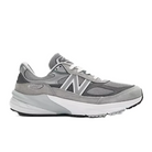 The New Balance Womens 990 v6 Wide Grey sneaker features mesh and suede panels, white accents, a white midsole, and a black outsole. Displayed in side profile, this USA-made shoe highlights NEW BALANCEs premium craftsmanship.