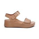 The Aetrex Women's Ariel Sand by AETREX WORLDWide INC is a stylish, tan wedge sandal with an open toe, ankle buckle strap, and thick platform—perfect comfort for those seeking plantar fasciitis-friendly shoes.