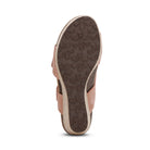 The image shows the bottom of the Aetrex Women's Ashley Espadrille Wedge Rose by AETREX WORLDWide INC, featuring a brown sole with a floral pattern and a light pink upper. This open-toe wedge provides stylish arch support for all-day comfort.