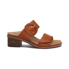 The Aetrex Womens Tatiana Cognac by AETREX WORLDWide INC is a brown leather sandal with a low adjustable block heel, Wide front strap, and decorative braided buckle. Designed for foot pain relief. Side view shown on white background.