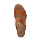 Top view of a single Aetrex Womens Tatiana Cognac slip-on sandal by AETREX WORLDWide INC, featuring brown leather, visible stitching, a cushioned insole for foot pain relief, and the Aetrex brand printed on the footbed.