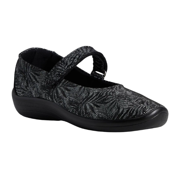 The ARCOPEDICO Arcopedico Womens Estrela Black Palm is a single black Mary Jane shoe featuring a textured floral pattern, Twin Arch Support for comfort, a hook-and-loop strap, and a thick supportive sole.