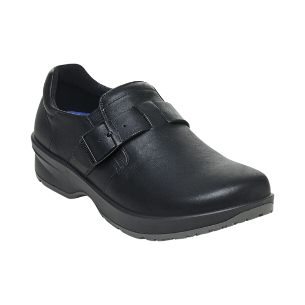 The Birkenstock Womens Caris Pro Leather Black shoe from BIRKENSTOCK features black leather, a low heel, rounded toe, side stitching, a decorative strap with buckle on the upper, and a slip-resistant PU outsole.