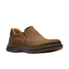 The CLARKS Mens Un Briley Step Wide Beeswax is a brown beeswax leather slip-on shoe with visible stitching, cushioned dark brown sole, and low heel for comfort and casual style, shown against a white background.